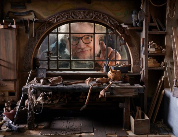 Director Guillermo del Toro admires a set from his 2022 stop-motion film "Pinocchio."