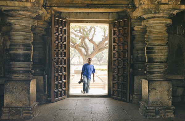 Sankar Raman walks through a tall doorway