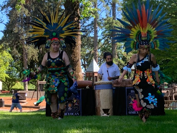 Eduardo Cruz on drums leads Luz Jaramillo (left) and Maria E. Cortes Duran of the Aztec dance group Huehca Omeyocan during the 2022 Make Music McMinnville festival. Photo by: David Bates