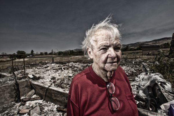 Clackamas County photographer Bruce MacGregor's "Aftermath Project" is documents the effects of 2020's wildfires. This is Edna on site of her burned home in Ashland.
