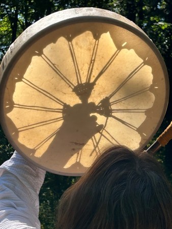 As a drummaker holds up her creation, the lacing cast shadows against the skin. Photo by: David Bates