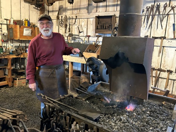 Blacksmith Gary Johnson fires coals in the forge at the Yamhill Valley Heritage Center in McMinnville. The forge will be open this weekend for demonstrations during the second annual Metal Arts Gift Show. show. Photo by: David Bates