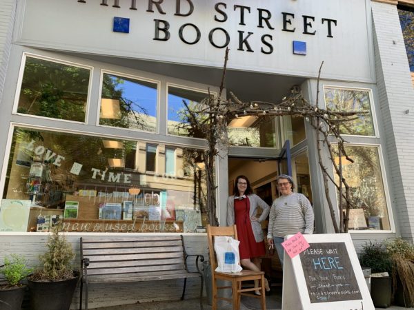 Sylla McClellan (right) laid off her staff at Third Street Books when the coronavirus forced the shop to close its doors, but has hired back one employee. Emily Kelly (left) hosts online story times, streaming Thursday mornings on Facebook. Photo by: David Bates